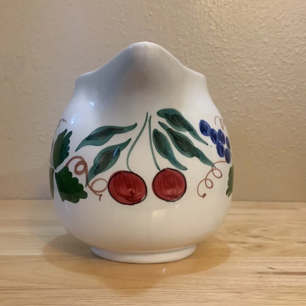 Crate & Barrel white ceramic pitcher hand painted with cherries and grapes.